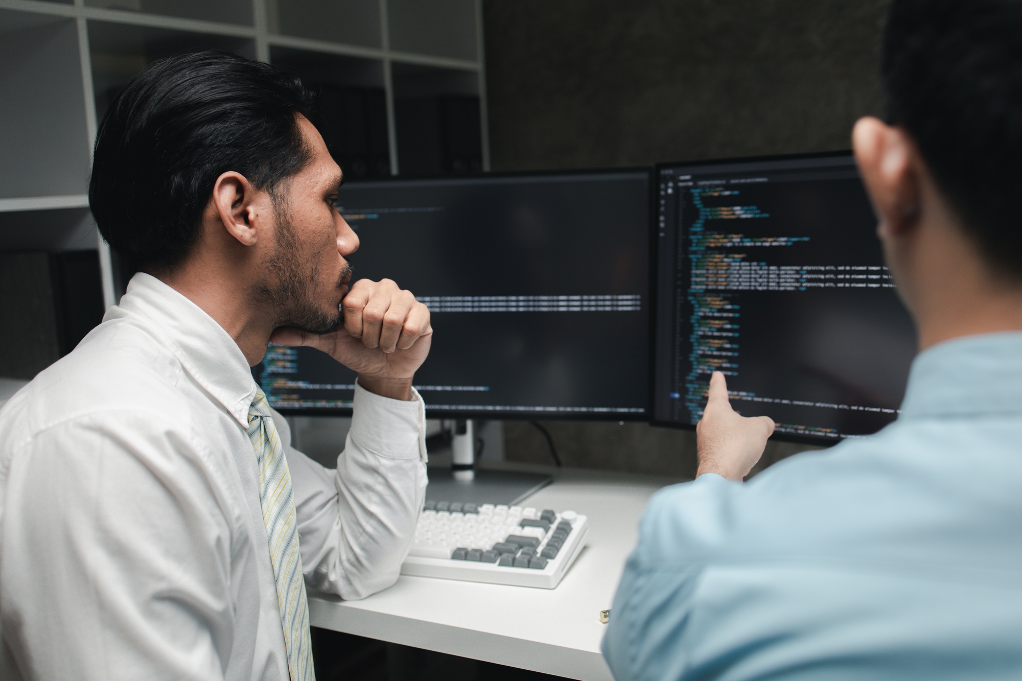 Group of programmers brainstorm together to write programs on the computer, designing programs to me
